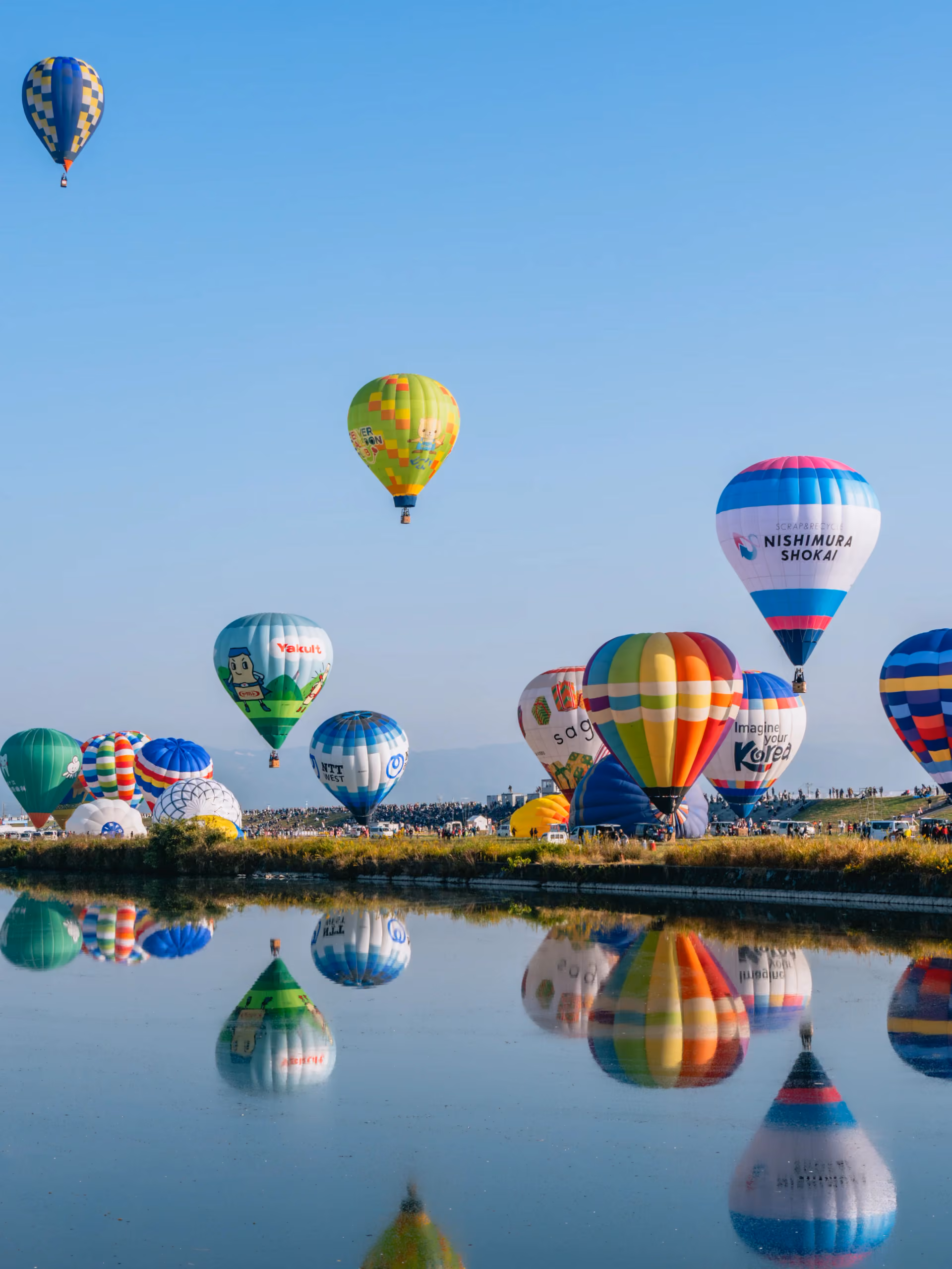 Hot air balloons rise over the Kase River at Saga International Balloon Fiesta