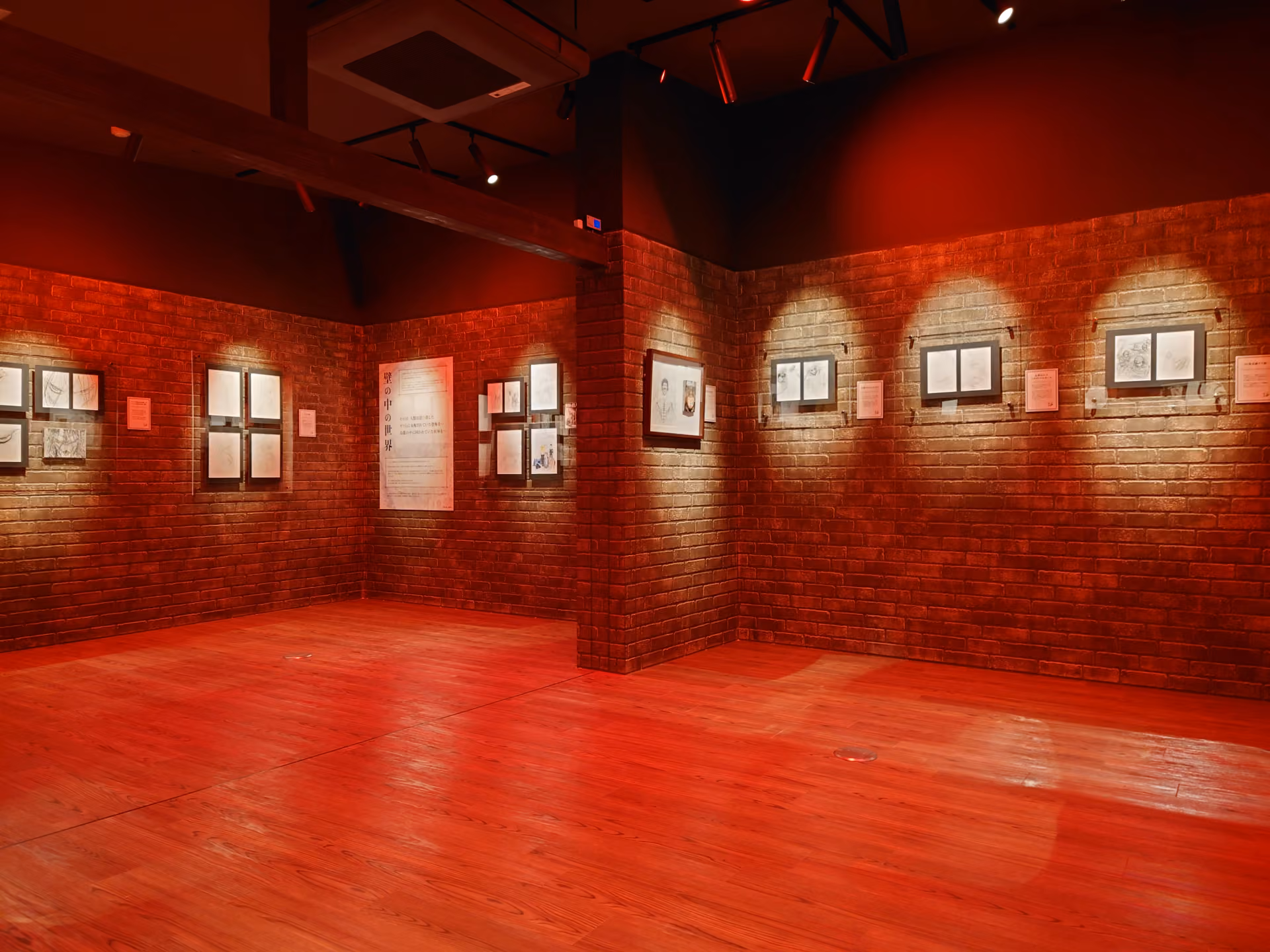 An exhibition room with exhibits on the walls at the ‘Attack on Titan in Hita Museum.